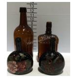Four brown bottles, two painted floral