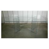 Glass table. Beveled edge glass. One leg has a