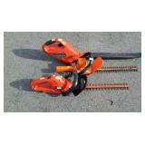 Two electric hedge trimmers and one battery