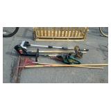 Group of long handled tools, rakes, scrub brush,