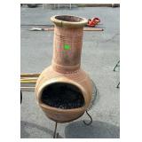 Clay fire pit on stand has been repaired, see