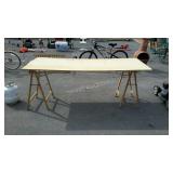 Work table top sitting on two saw horses