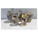 5 Beer steins - some with German writing, one is
