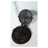 Cast iron waffle iron with handled base, marked