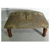 Tapestry style footstool with palm tree pattern.