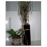 Two faux plants in ceramic vessels.