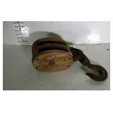 Older double pulley with iron swivel hook.