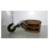 Older double pulley with iron swivel hook.