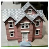 Dollhouse with accessories. Open back.