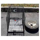Small metal folding pet cage and trailer tire,