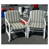 Pair of green striped PVC style patio chairs on