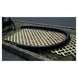 Piece of lattice and black drain pipe