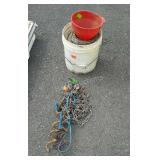 Bucket with partial roll of barbed wire, dog tie