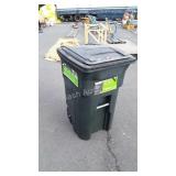 Green plastic trashcan