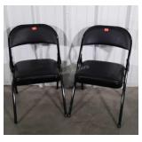Two black padded seat folding Chairs
