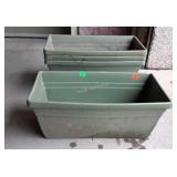 Four green plastic planters