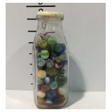 Milk glass full of marbles