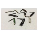 Group of pocket knives and sharpening block