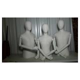 Three cloth covered mannequins with articulating