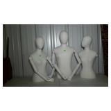 Three cloth-covered mannequins with articulating