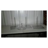 Four metal mannequin stands one round three
