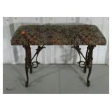 Upholstered stool with cast iron base.