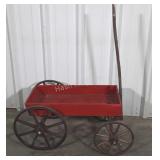 Wagon, red painted with wood spoke wheels.