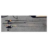 Group of four fishing poles, two have reels, two