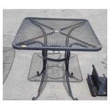 Wrought Iron patio table that is 28 by 28 by 29