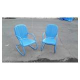 Two blue metal porch patio chairs, one is a