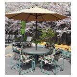 Round glass top patio table with four chairs,