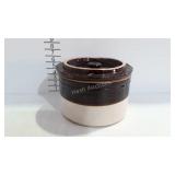 Brown over whitemcheese crock with lid, which may