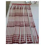 Red beaded door curtain or room divider, appears