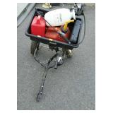 Spreader with two gas cans and a small sprayer