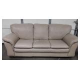 Tan pleather sofa, cushions are attached do not