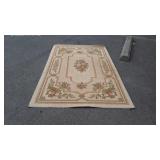 Tan area rug with flower design 97 by 60