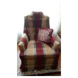 Upholstered chair in plaid with floral throw