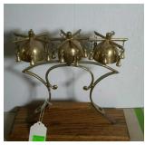 Brass bell trio on oak stand. 11" high.