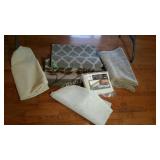 Group lot of throw rugs and rug pads.