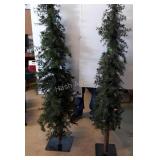 Two six foot artificial Christmas trees, one is