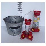 Two humming bird feeders, and galvanized bucket