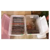 Record albums, two tote bins with lids, one is