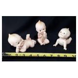 Three kewpie piano baby figurines