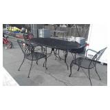 Wrought iron patio table and 4 chairs, 72 in by