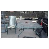 Glass top patio table and two chairs, measures 60