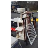 Carpeted cat pole and sections of safety gate