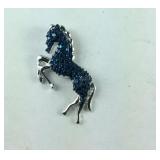 Blue diamond accent horse pendant in blue ion