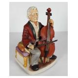 Painted porcelain cello player statue, has