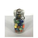 Small jar of marbles with glass lid