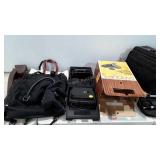 Suitcases, slide projectors, (one has no cord,